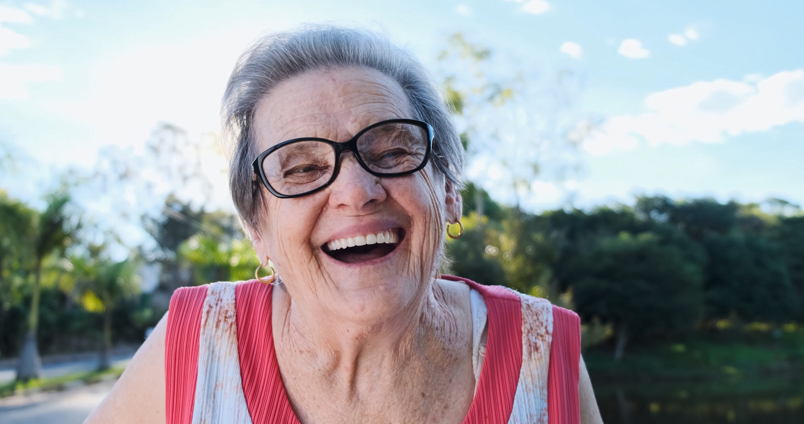 smiling old latin woman. beautiful senior woman looking at the c